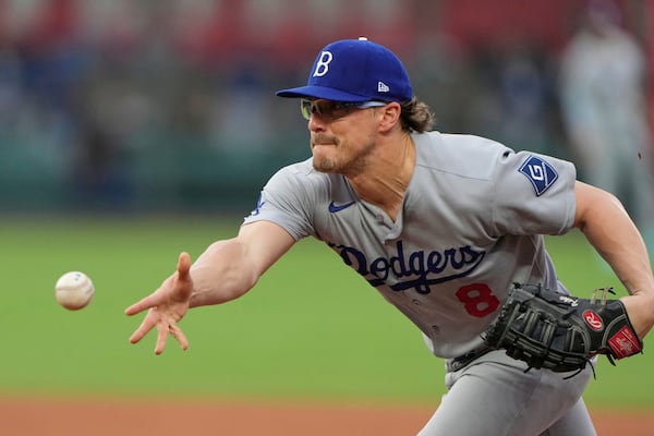 Los Angeles Dodgers first baseman Kike Hernandez tosses the ball to the pitcher at first to get the out on Kansas City Royals' Jac Caglianone during the fourth inning of a baseball game Sunday, June 29, 2025, in Kansas City, Mo. (AP Photo/Charlie Riedel)