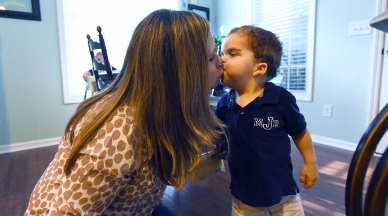 Keri Janton kisses her son Max, 4, after dinner at their home on Tuesday, September 22, 2015. Max Janton, 4, was born with a rare and serious condition.  HYOSUB SHIN / HSHIN@AJC.COM