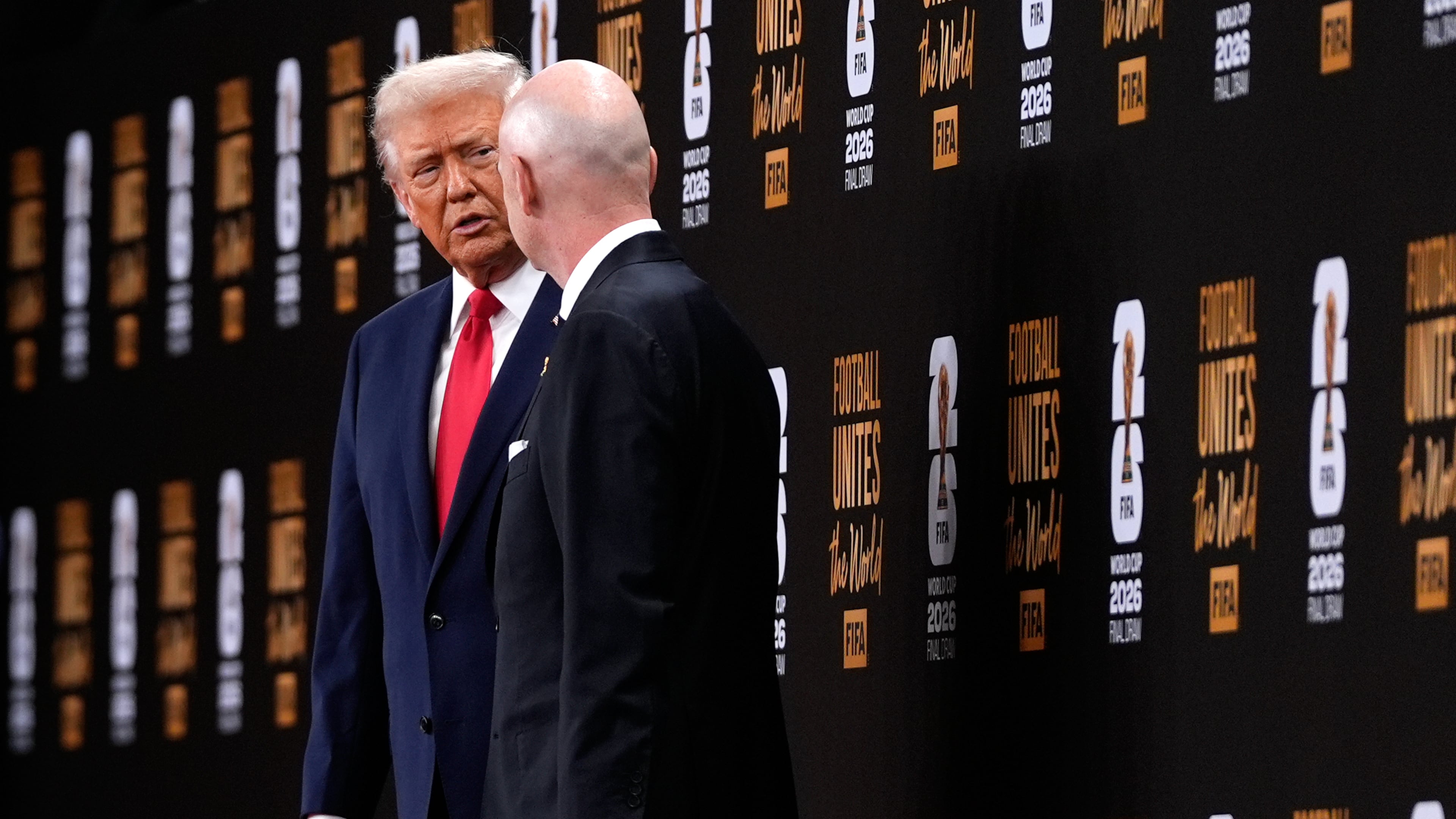 President Donald Trump speaks with FIFA President Gianni Infantino as they leave after the draw for the 2026 soccer World Cup at the Kennedy Center in Washington, Friday, Dec. 5, 2025. (AP Photo/Julia Demaree Nikhinson)