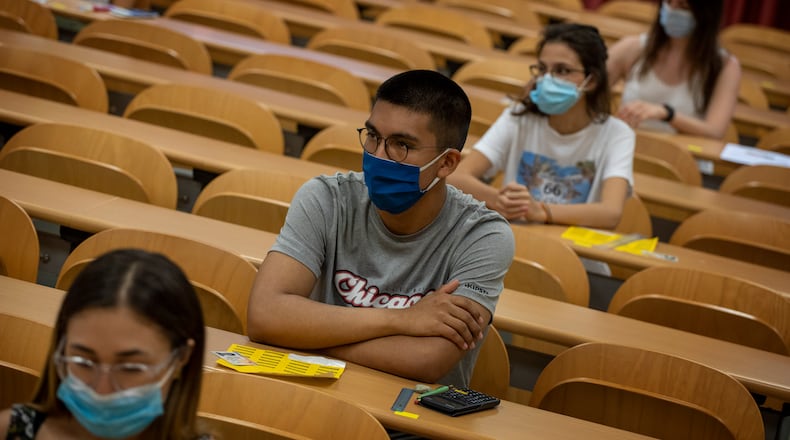 Students wearing face masks sit at their desks keeping social distance, ahead of a selectivity exam on Tuesday, July 7, 2020 in Sabadell, outside Barcelona, Spain.