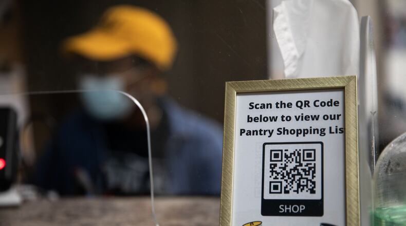 A scannable QR code sits on the pantry’s front desk on Tuesday, Aug. 17, 2021, allowing students to digitally view the pantry’s shopping list. The Kennesaw State University food pantry relocated to the Carmichael Student Center in February 2021, allowing the pantry to serve more students with an expanded selection of items. (Photo/Ryan Cameron for the Atlanta Journal Constitution)