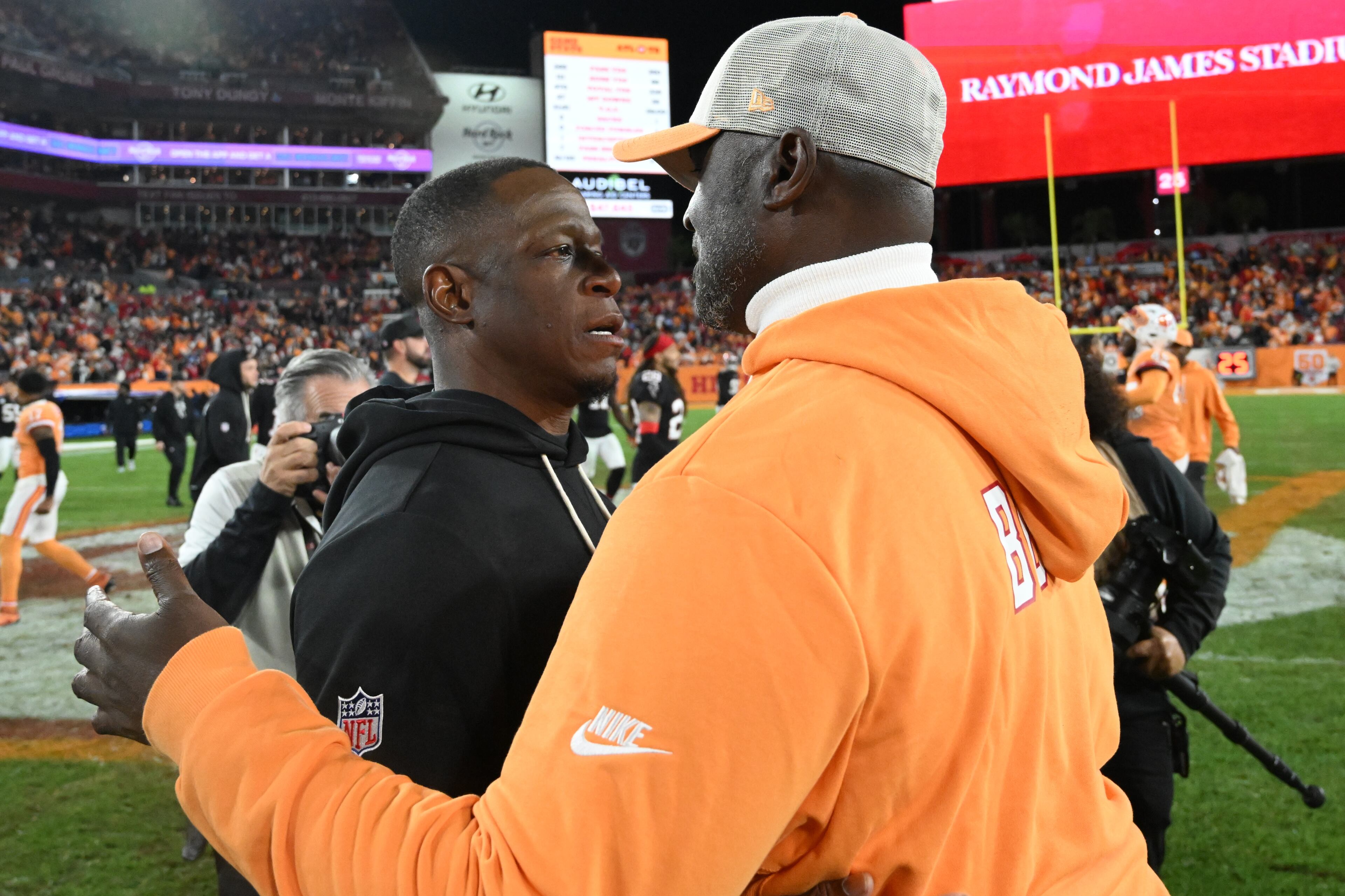 Atlanta Falcons head coach Raheem Morris speaks with Tampa Bay Buccaneers head coach Todd Bowles after an NFL football game, Thursday, Dec. 11, 2025, in Tampa, Fla. (AP Photo/Jason Behnken)