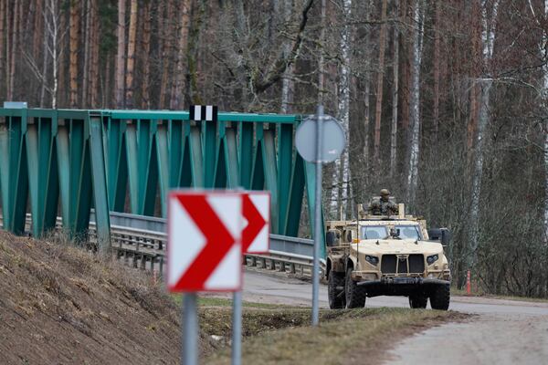 A military vehicle parked at a bridge towards at a training range in Pabrade, north of the capital Vilnius, Lithuania, Thursday, March 27, 2025. (AP Photo/Mindaugas Kulbis)