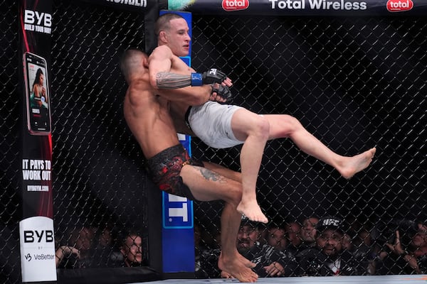 Alexandre Pantoja takes down Kai Kara-France in a flyweight title fight at UFC 317, Saturday, June 28, 2025, in Las Vegas. (AP Photo/John Locher)