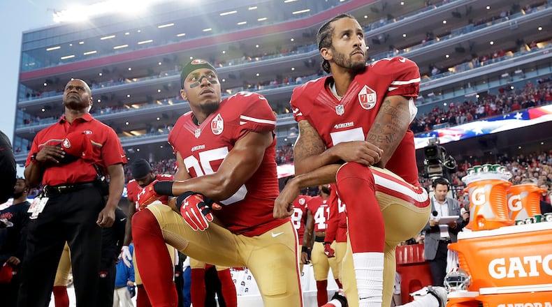 San Francisco 49ers safety Eric Reid (35) and quarterback Colin Kaepernick (7) kneel during the national anthem before an NFL football game against the Los Angeles Rams in September 2016. (AP Photo/Marcio Jose Sanchez, File)