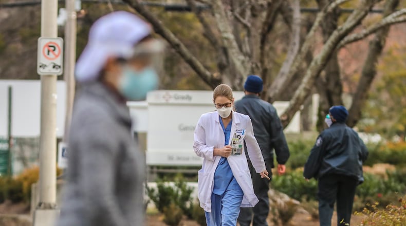 In this file photo, Grady Hospital healthcare workers arrive for work. Grady reports, 99% of its staff is vaccinated. (John Spink / John.Spink@ajc.com)