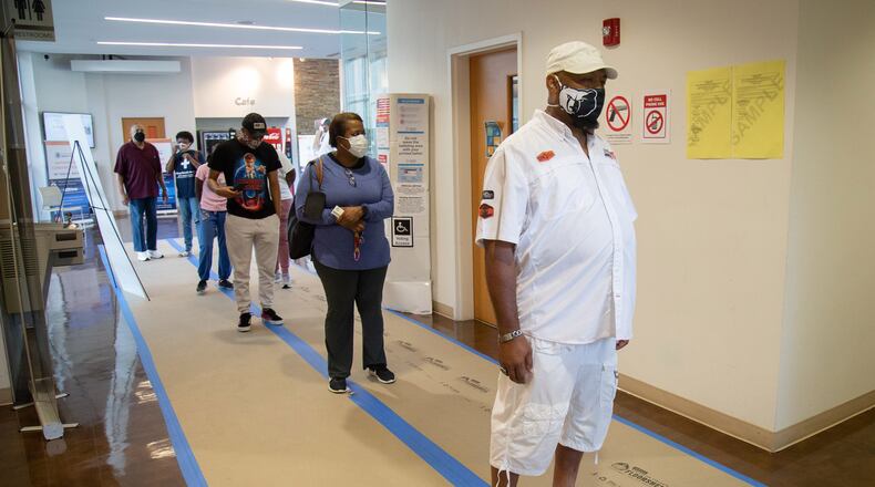 Emanual Frazier (R) stands in line to vote at The Wolf Creek Library in Atlanta Saturday, August 1, 2020. STEVE SCHAEFER / SPECIAL TO THE AJC