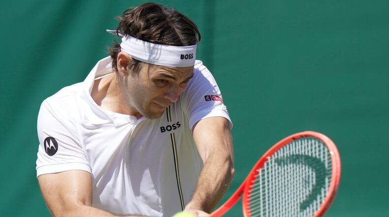 Taylor Fritz of the United States returns the ball to Patrick Kypson of the United States in their second round men's singles match at the Wimbledon Tennis Championships in London, Thursday, July 2, 2026. (AP Photo/Brian Inganga)