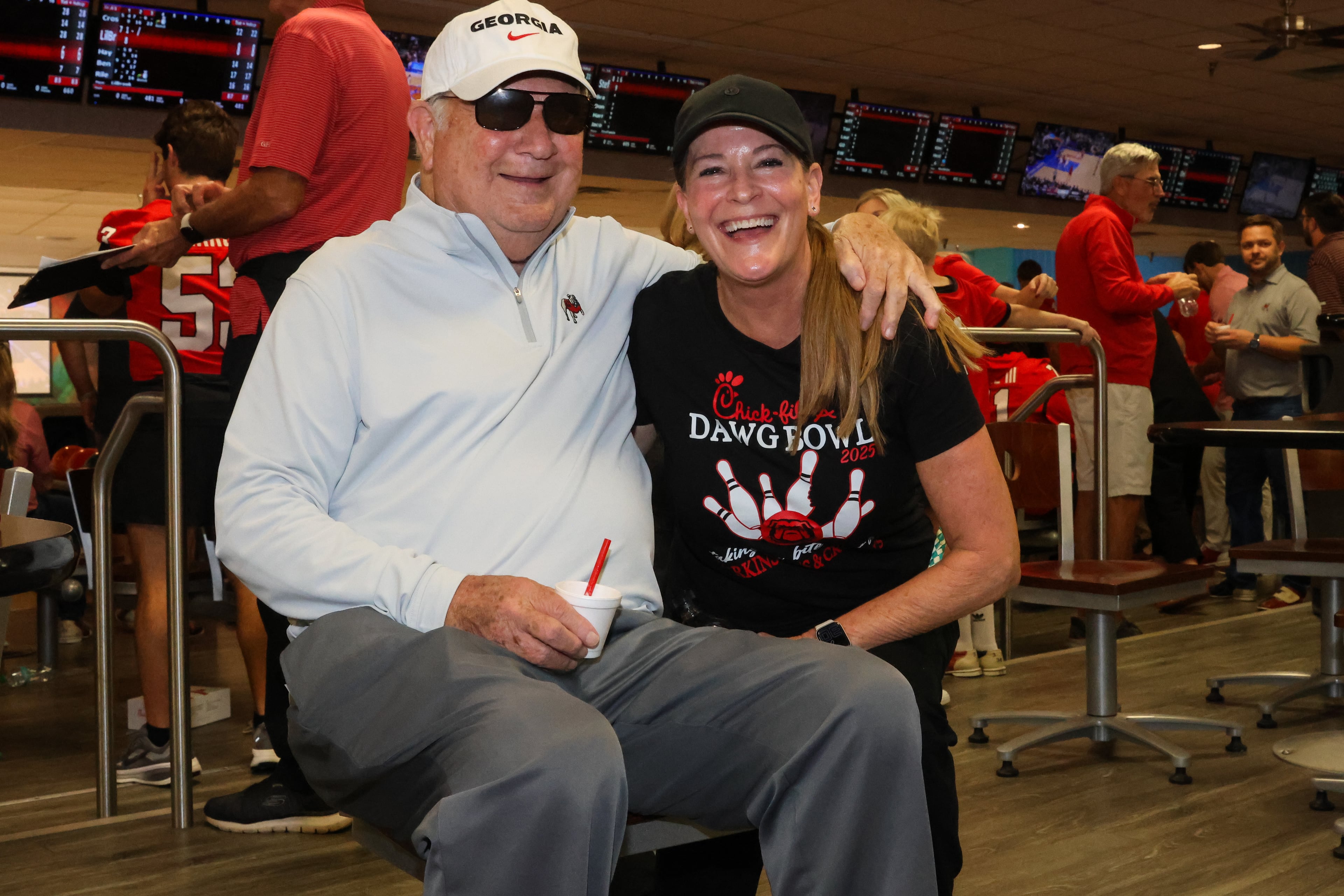 Former UGA football coach Jim Donnan (left) poses for a photo with Katharyn Richt during the third annual Chick-fil-A Dawg Bowl fundraiser for Parkinson’s and Crohn’s disease research at Showtime Bowl in Athens on Wednesday, Oct. 22, 2025. Donnan coached the Bulldogs from 1996 to 2000. (C.J. Bartunek for the AJC)