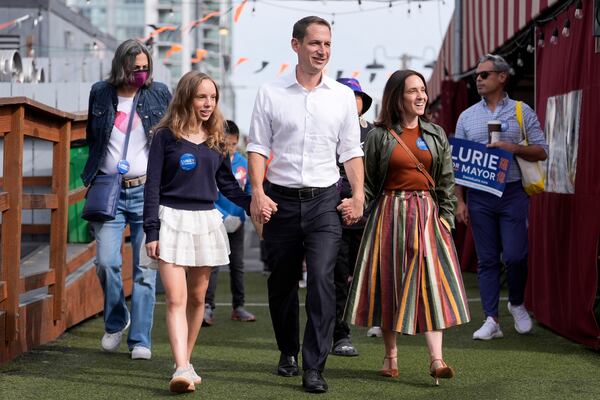 FILE - San Francisco mayoral candidate Daniel Lurie, middle, walks with his daughter Taya Lurie, foreground left, and his wife, Becca Prowda, foreground right, while campaigning in San Francisco, Saturday, Oct. 26, 2024. (AP Photo/Jeff Chiu, File)