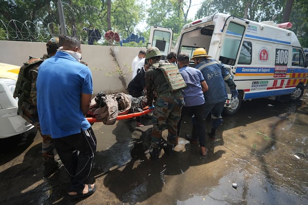 EDS NOTE: GRAPHIC CONTENT - Rescue workers at the site of an airplane that crashed in India's northwestern city of Ahmedabad in Gujarat state, Thursday, June12, 2025. (AP Photo/Ajit Solanki)