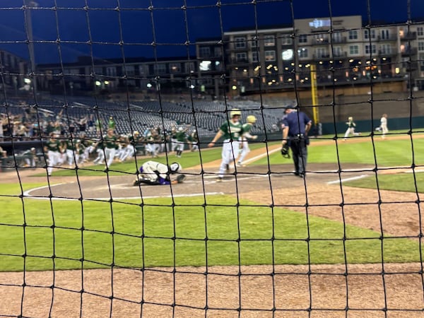 Quinn Davis scores the winning run in the bottom of the eighth as Blessed Trinity stunned Cartersville 7-6. Cartersville catcher Julez Pratt can't believe the misfortune. May 22, 2025.