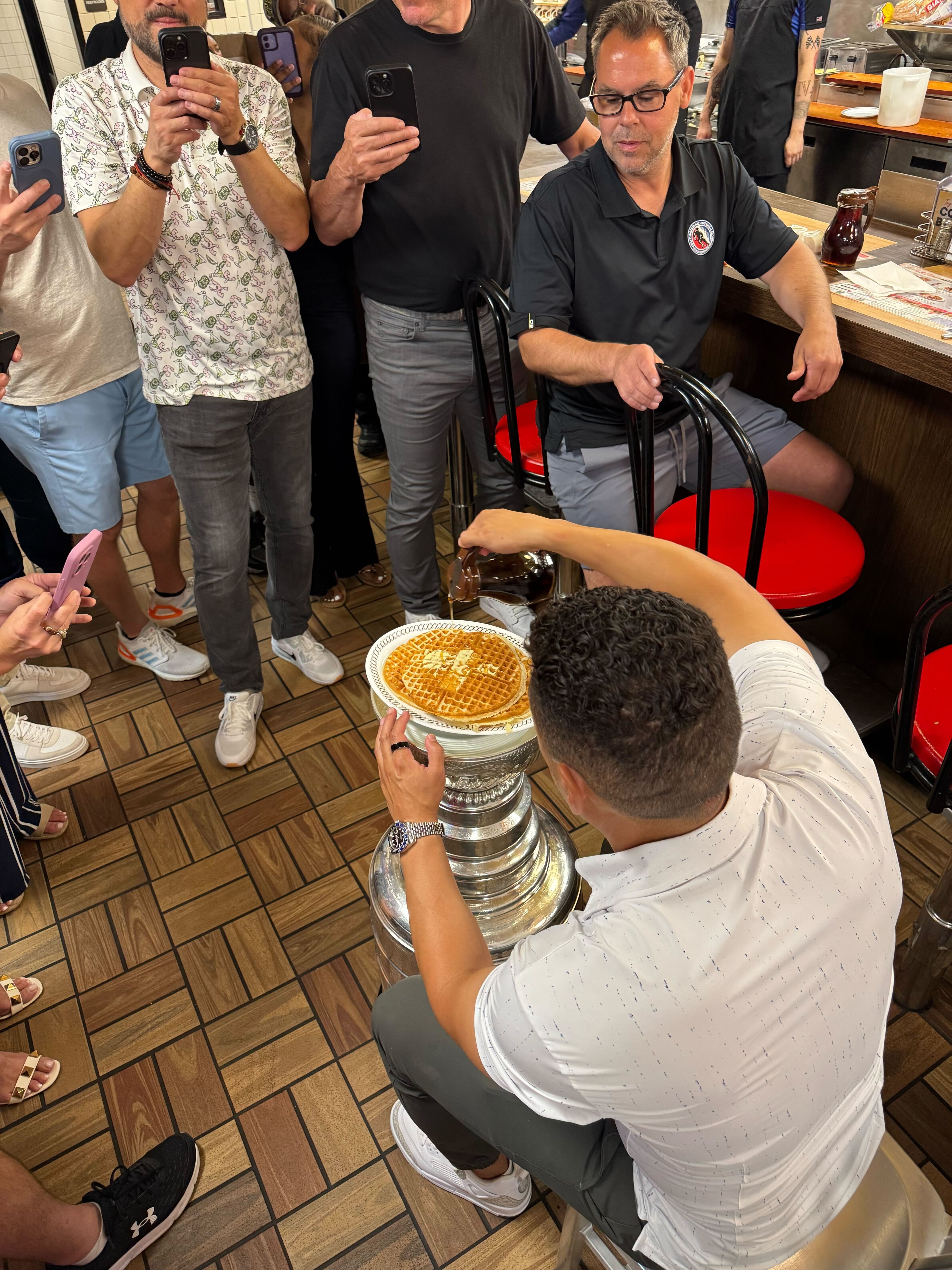 Mike Huff eats a waffle out of the Stanley Cup at Waffle House. (Courtesy of Brad Pendergrass)