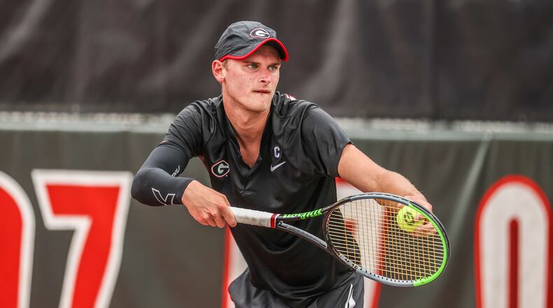 Georgia tennis player Hamish Stewart prepares to serve during a match against Alabama at Dan Magill Tennis Complex in Athens. The Bulldogs are hosting the SEC Tournament this week. (Photo by Mackenzie Miles/UGA Athletics)