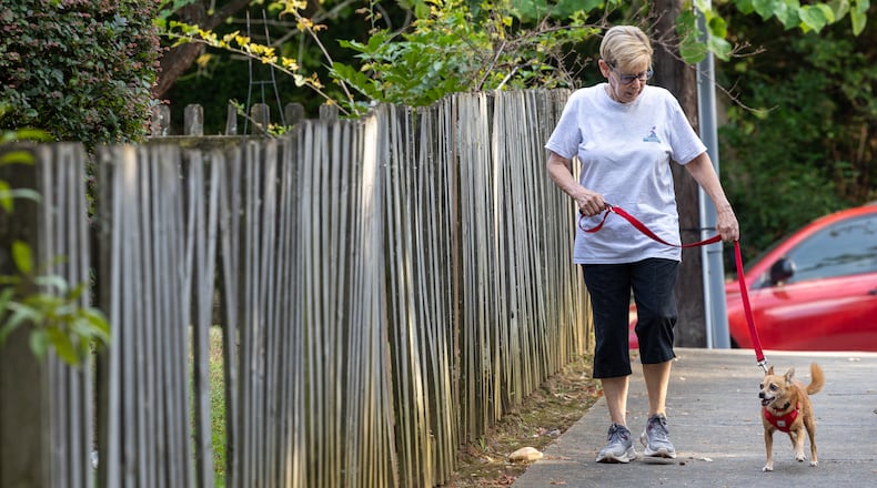 Volunteer Lois Gross walks Baby for a client in Decatur.  PHIL SKINNER FOR THE ATLANTA JOURNAL-CONSTITUTION