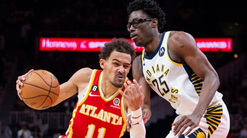 Atlanta Hawks guard Trae Young drives past Indiana Pacers forward Jalen Smith during the first half of an NBA basketball game, Saturday, March 25, 2023, in Atlanta. (AP Photo/Hakim Wright Sr.)