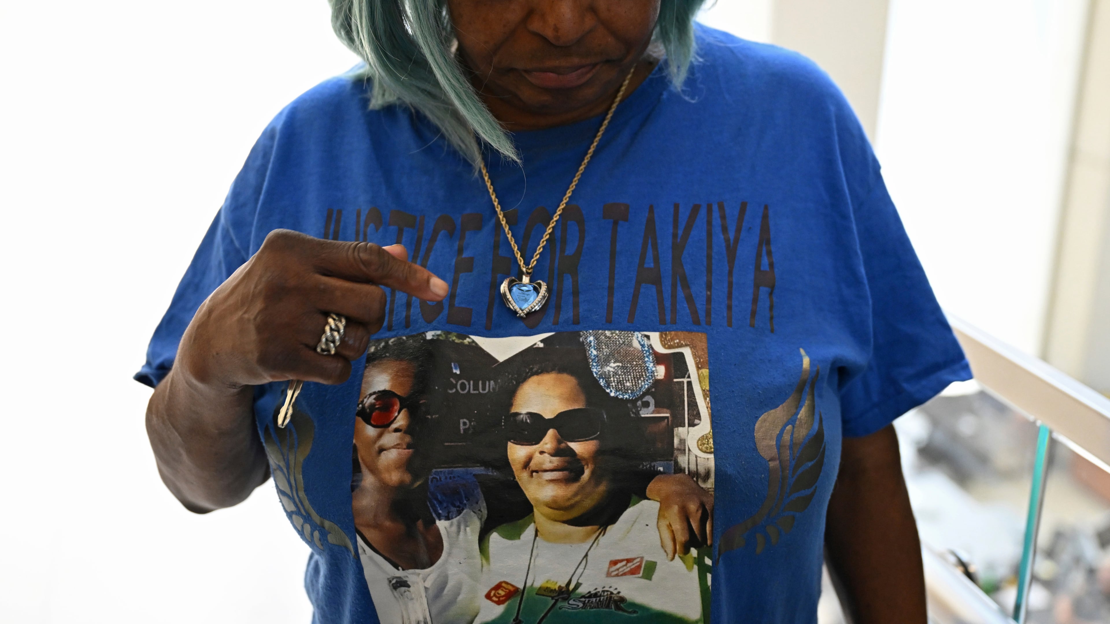 FILE - Nadine Young, grandmother of Ta'Kiya Young, shows her shirt to reporters after arraignment proceedings of Blendon Township police officer Connor Grubb, Aug. 14, 2024, at the Franklin County Court of Common Pleas in Columbus. (AP Photo/David Dermer, file)