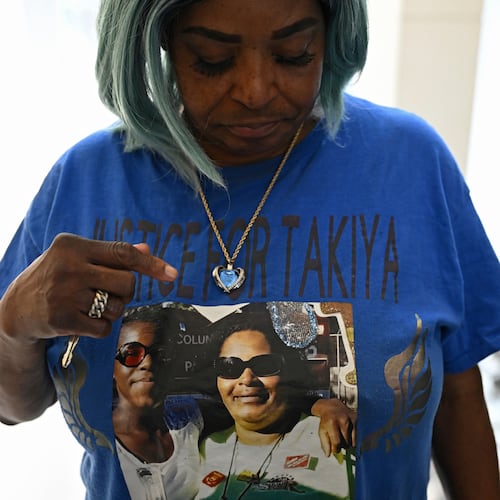 FILE - Nadine Young, grandmother of Ta'Kiya Young, shows her shirt to reporters after arraignment proceedings of Blendon Township police officer Connor Grubb, Aug. 14, 2024, at the Franklin County Court of Common Pleas in Columbus. (AP Photo/David Dermer, file)