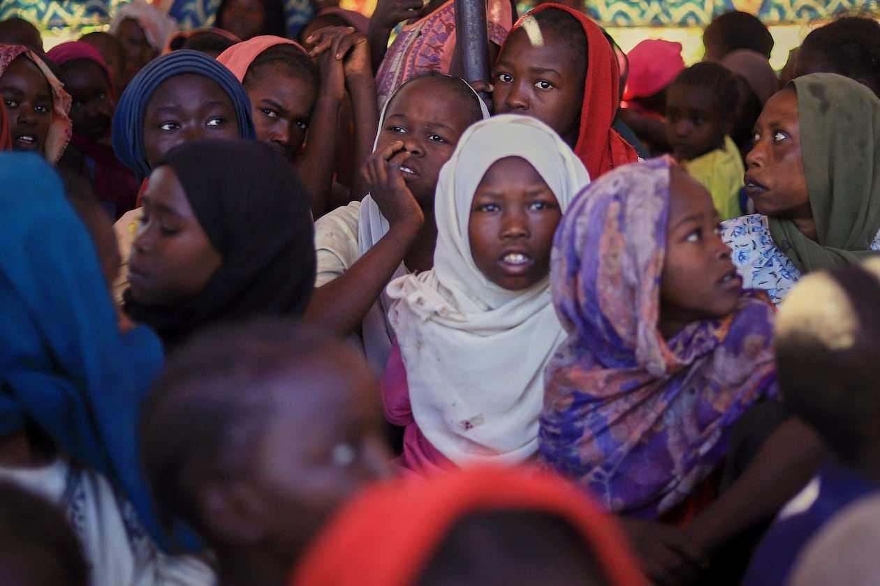 This photo released by The Norwegian Refugee Council (NRC), shows displaced women and children from el-Fasher at a camp where they sought refuge from fighting between government forces and the RSF, in Tawila, Darfur region, Sudan, Monday, Nov. 3, 2025. (NRC via AP)