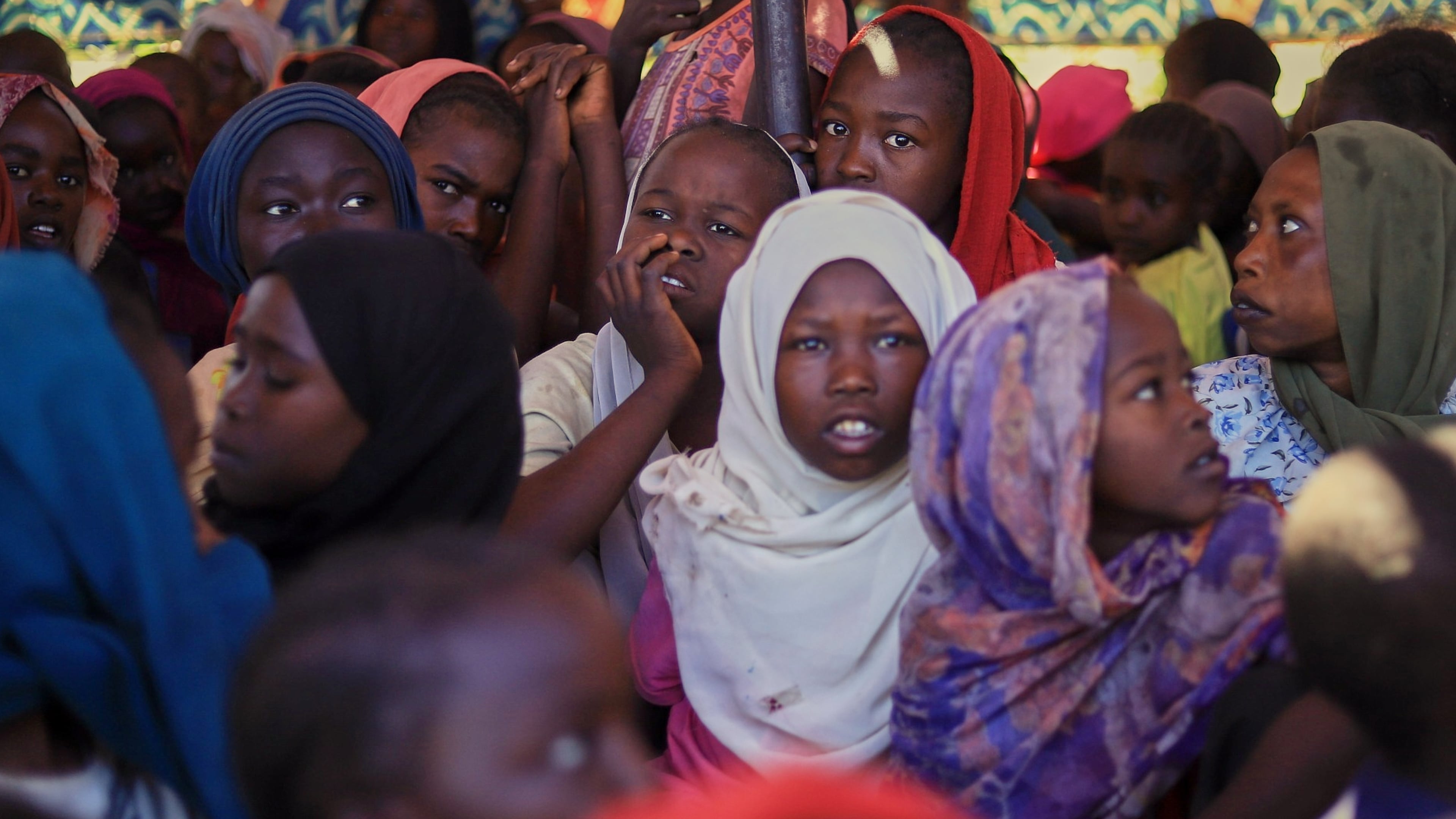 This photo released by The Norwegian Refugee Council (NRC), shows displaced women and children from el-Fasher at a camp where they sought refuge from fighting between government forces and the RSF, in Tawila, Darfur region, Sudan, Monday, Nov. 3, 2025. (NRC via AP)