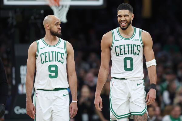 Boston Celtics' Jayson Tatum (0), right, reacts beside Derrick White after falling on a flagrant fowl by Orlando Magic's Kentavious Caldwell-Pope during the second half in Game 1 of a first-round NBA playoff basketball series Sunday, April 20, 2025, in Boston. (AP Photo/Michael Dwyer)