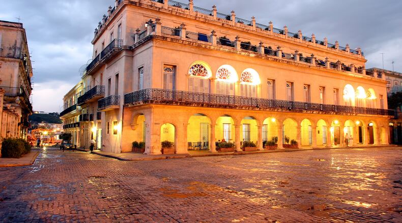 HAVANA, CUBA - SEPTEMBER 4: An exterior view of the Santa Isabel Hotel (est. 1867) and the Plaza de Armas, a main tourist square, on September 4, 2004 in old Havana, Cuba. The Plaza de Armas has been carefully restored to maintain the original 16th century Spanish colonial architecture and atmosphere. The square is the oldest in Havana, originally named "Plaza de la Iglesia" (Church Square), but received its present name when the Spanish governorship relocated to Havana in the 16th century, and the Spanish military began to use it for practices, parades, and other military events. (Photo by Sven Creutzmann/Mambo Photography/Getty Images)