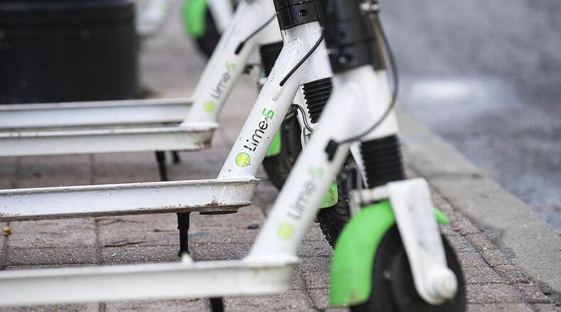 01/04/2019 — Atlanta, Georgia — Lime Scooters sit parked on Peachtree Street in Atlanta’s Midtown community, Friday, January 4, 2019. (ALYSSA POINTER/ALYSSA.POINTER@AJC.COM)