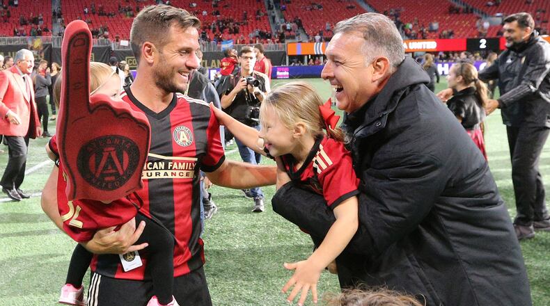Atlanta United manager Gerardo Martino and Kevin Kratz celebrate a 2-1 victory over the Chicago Fire during a MLS soccer match on Sunday, Oct 21, 2018, in Atlanta. Curtis Compton/ccompton@ajc.com