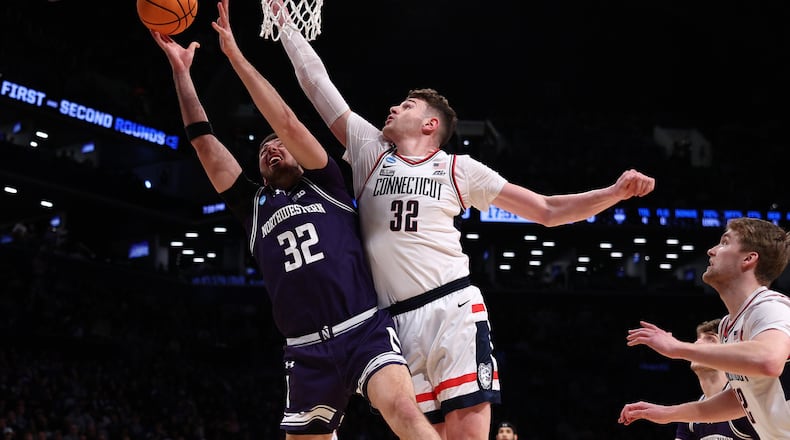 Donovan Clingan (32) of the Connecticut Huskies defends against Blake Preston (32) of the Northwestern Wildcats during the first half in the second round of the NCAA Tournament at Barclays Center on March 24, 2024, in New York City. (Elsa/Getty Images/TNS)