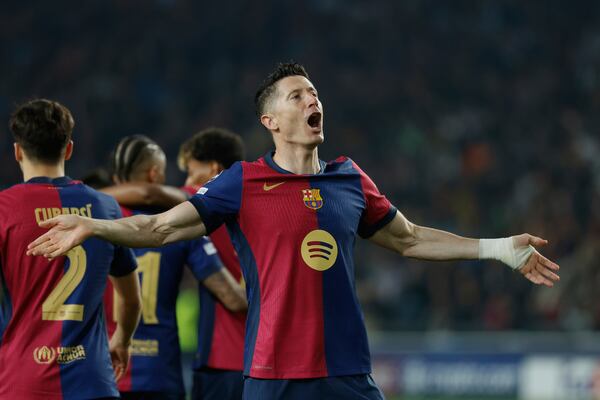 Barcelona's Robert Lewandowski celebrates after scoring his side's second goal during the Champions League quarterfinals first leg soccer match between Barcelona and Borussia Dortmund, at the Lluis Companys Olympic stadium in Barcelona, Spain, Wednesday, April 9, 2025. (AP Photo/Joan Monfort)
