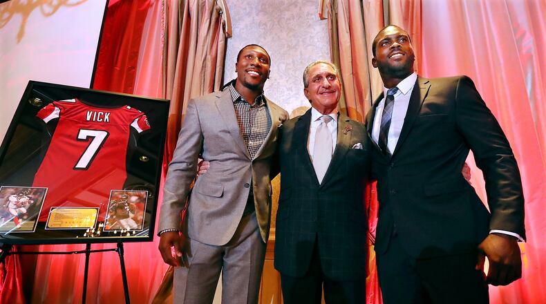 June 12, 2017, Atlanta: Atlanta Falcons owner Arthur Blank honors former Falcons quarterback Michael Vick (right) and wide receiver Roddy White as they officially retire from the NFL on Monday, June 12, 2017, in Atlanta. Curtis Compton/ccompton@ajc.com