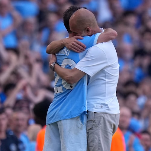 Manchester City's head coach Pep Guardiola hugs Manchester City's Bernardo Silva as he played last match for the team during a Premier League soccer match between Manchester City and Aston Villa in Manchester, England, Sunday, May 24, 2026. (AP Photo/Alastair Grant)