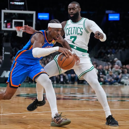 Oklahoma City Thunder guard Shai Gilgeous-Alexander, left, drives to the basket against Boston Celtics guard Jaylen Brown (7) during the first half of an NBA basketball game, Wednesday, March 25, 2026, in Boston. (AP Photo/Charles Krupa)