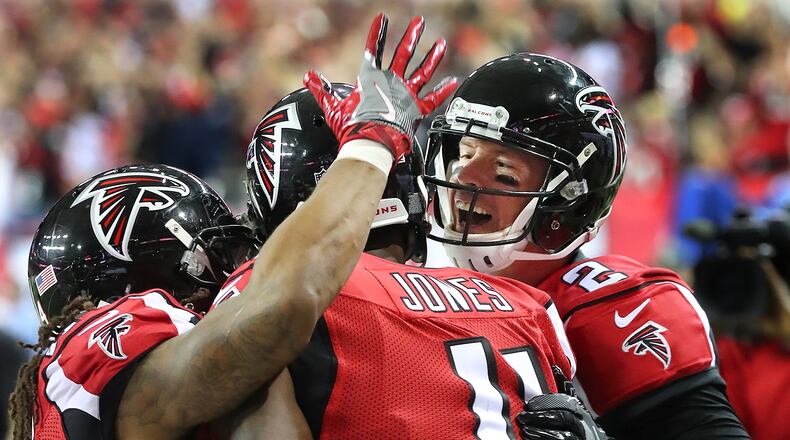 January 1, 2017, Atlanta: Falcons quarterback Matt Ryan and running back Devonta Freeman celebrate his touchdown pass to Julio Jones (center) for a 21-10 lead over the Saints during the second quarter in an NFL football game on Sunday, Jan. 1, 2017, in Atlanta. Curtis Compton/ccompton@ajc.com
