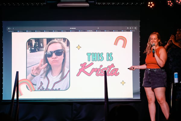 Stephanie Groveman gives a presentation about her friend Krista Dillard at a Pitch-A-Friend dating event at Lore nightclub on Tuesday, July 1, 2025, in Atlanta. The event allows people to pitch their single friends to the crowd using a slideshow presentation. (Natrice Miller/AJC)
