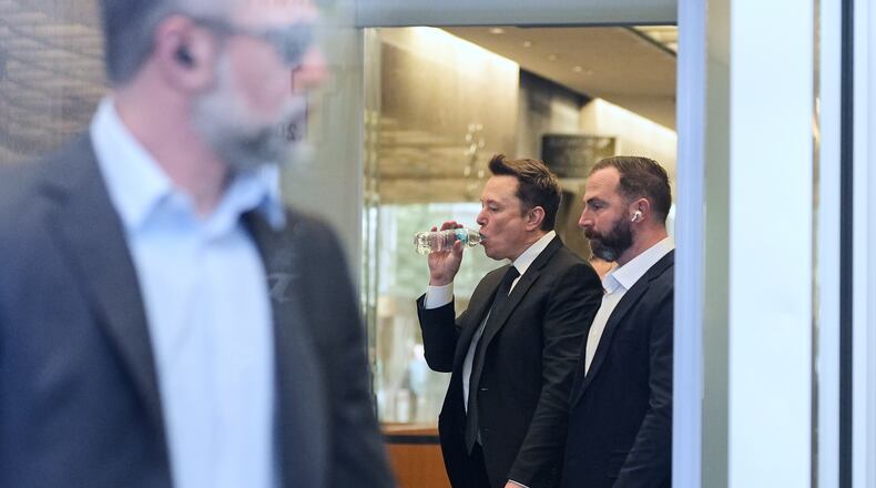 Elon Musk, center, arrives for a Twitter shareholder trial at the U.S. District Court for the Northern District of California, Wednesday, March 4, 2026, in San Francisco. (AP Photo/Godofredo A. Vásquez)