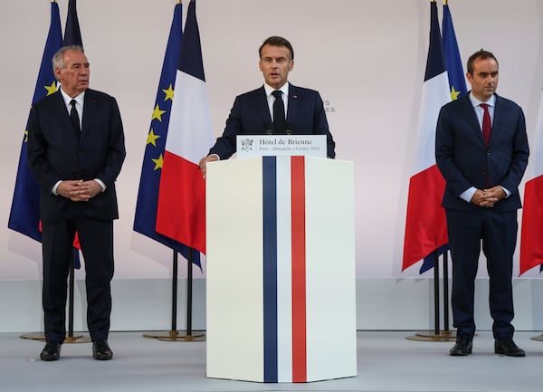French President Emmanuel Macron speaks to the army leaders flanked by Prime Minister Francois Bayrou, left, and Defense Minister Sebastien Lecornu at the Hotel le Brienne, Sunday, July 13, 2025, ahead of the Bastille Day parade in Paris. (Ludovic Marin, Pool Photo via AP)