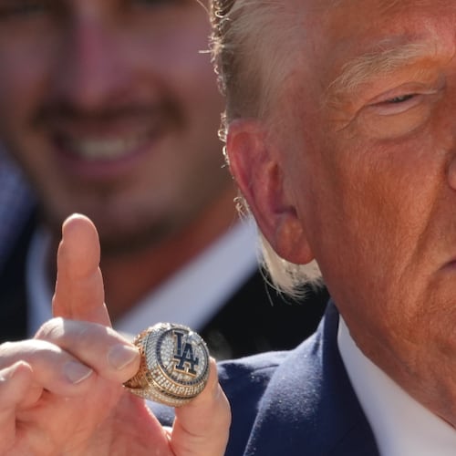President Donald Trump holds a championship ring during an event to honor the 2025 World Series champions Los Angeles Dodgers in the Rose Garden of the White House, Thursday, July 23, 2026, in Washington. (AP Photo/Alex Brandon)