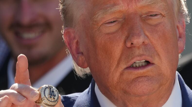 President Donald Trump holds a championship ring during an event to honor the 2025 World Series champions Los Angeles Dodgers in the Rose Garden of the White House, Thursday, July 23, 2026, in Washington. (AP Photo/Alex Brandon)