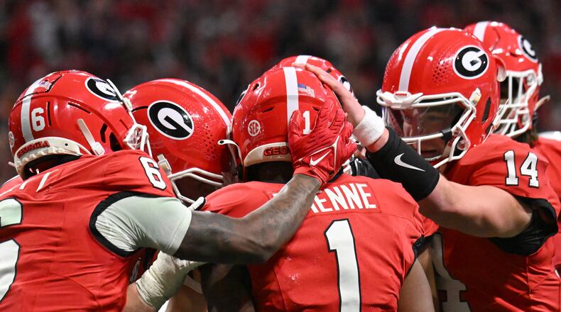 Georgia running back Trevor Etienne (1) celebrates with teammates after scoring a touchdown during the second half in the SEC Championship football game at the Mercedes-Benz Stadium, Saturday, December 7, 2024, in Atlanta. Georgia won 22-19 over Texas in overtime. (Hyosub Shin / AJC)
