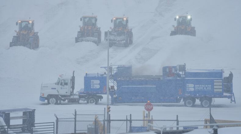 Airport crew plow snow during a winter storm in Philadelphia, Sunday, Jan. 25, 2026. (AP Photo/Matt Rourke)