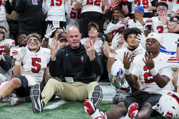 Bowdon head coach Rich Fendley and his players celebrate their fourth-straight championship after a 35-31 win against Lincoln County during the Class A Division II GHSA football championships at Mercedes-Benz Stadium on Monday, Dec. 15, 2025, in Atlanta. (Jason Getz/AJC)