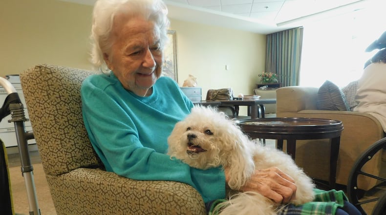 Carolyn Barlow enjoys holding therapy dog Shayna. Happy Tails volunteer Gerry Serotte brought Shayna to a pet therapy visit at Lenbrook senior community in Atlanta. Photo contributed by Lenbrook.