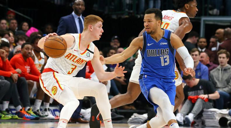 Atlanta Hawks guard Kevin Huerter (3) is guarded by Dallas Mavericks guard Jalen Brunson (13) in the first half during an NBA basketball game Saturday, Feb. 1, 2020 in Dallas. (AP Photo/Richard W. Rodriguez)