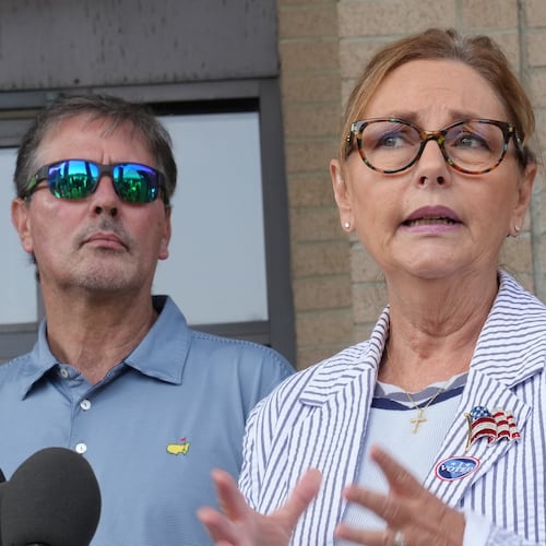 Larry Nordone looks on as his wife, U.S. Sen. Darline Graham, R-S.C., speaks to reporters after she voted in a special Republican primary to replace her brother, U.S. Sen. Lindsey Graham, R-S.C., on November ballots on Tuesday, Aug. 11, 2026, in Florence, S.C. (AP Photo/Meg Kinnard)
