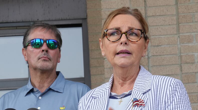 Larry Nordone looks on as his wife, U.S. Sen. Darline Graham, R-S.C., speaks to reporters after she voted in a special Republican primary to replace her brother, U.S. Sen. Lindsey Graham, R-S.C., on November ballots on Tuesday, Aug. 11, 2026, in Florence, S.C. (AP Photo/Meg Kinnard)