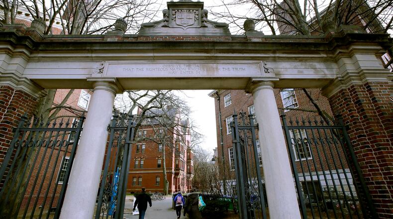 FILE - In this Dec. 13, 2018, file photo, a gate opens to the Harvard University campus in Cambridge, Mass. The U.S. Education Department said Wednesday, Feb. 12, 2020, it is investigating foreign gifts made to Harvard and Yale as part of a broader review of international money flowing to American universities. (AP Photo/Charles Krupa, File)