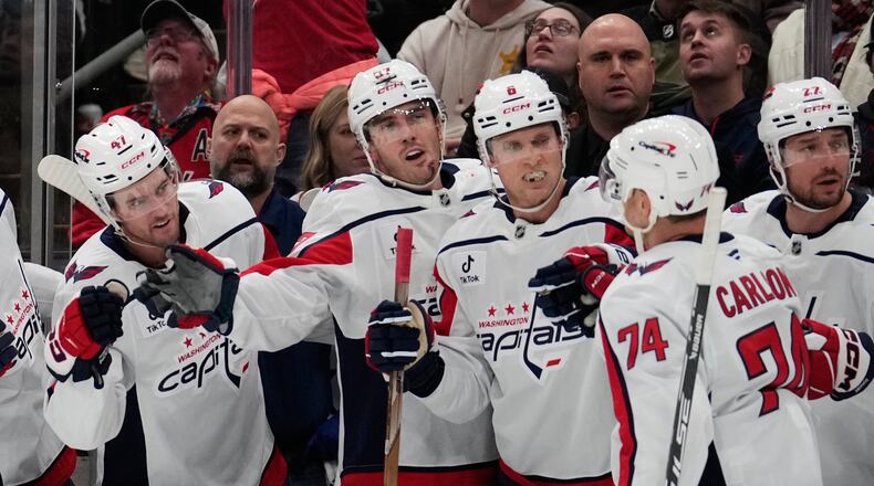Washington Capitals defenseman John Carlson (74) is congratulated by teammates after scoring in the second period of an NHL hockey game against the Columbus Blue Jackets Friday, Oct. 24, 2025, in Columbus, Ohio. (AP Photo/Sue Ogrocki)