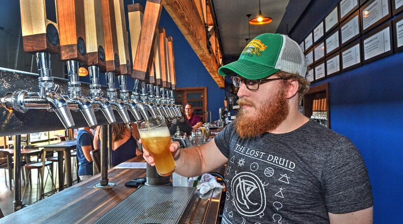 The Lost Druid bartender, Joey Lynch, pours a Mistic Rattler, a combination of lemonade and IPA.