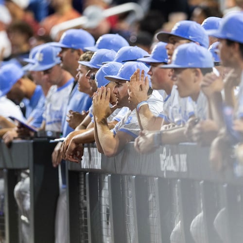 North Carolina players watch from the dugout as Oklahoma goes to bat in the ninth inning of Game 3 of the NCAA College World Series baseball finals in Omaha, Neb., Monday, June 22, 2026. (AP Photo/Rebecca S. Gratz)